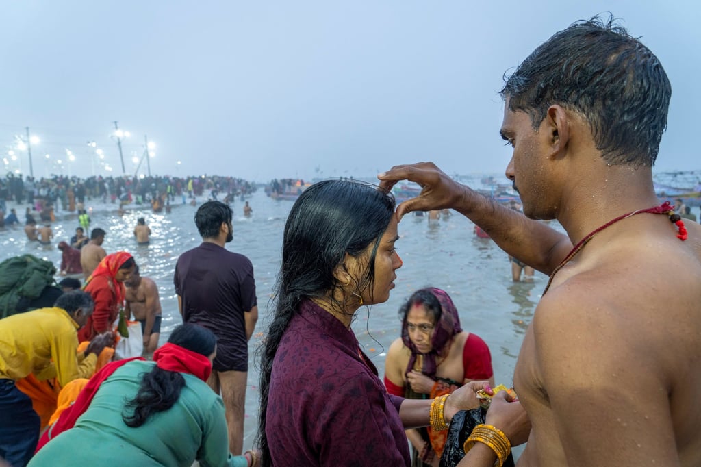 A Hindu devotee puts a vermillion mark on the forehead of his wife after bathing at the confluence of the Ganges, the Yamuna and the mythical Saraswati rivers on the first day of the 45-day-long Maha Kumbh Mela. Photo: AP