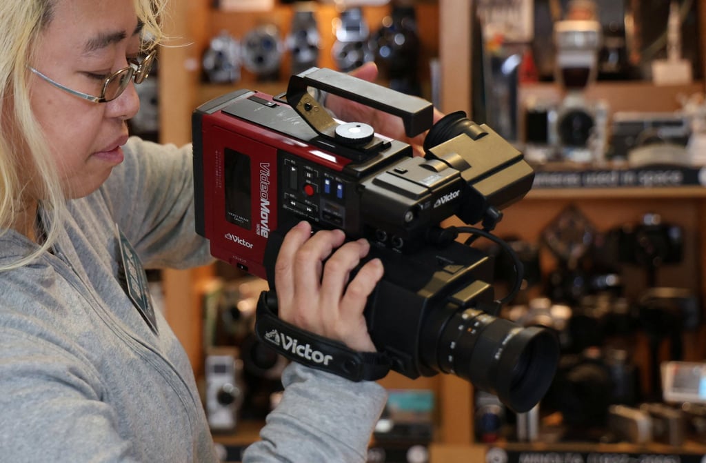 Deputy curator Barbara Asuka holds a VHS-C videocassette format camera exhibited at Tokyo’s Extinct Media Museum. Photo: Reuters Deputy curator Barbara Asuka holds a VHS-C videocassette format camera exhibited at Tokyo’s Extinct Media Museum. Photo: Reuters