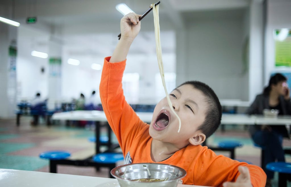 A boy gets his noodle fix at a boarding school in Taishan, Guangdong province, a dish that came to southern China courtesy of Chinese railroad workers. Photo: Imaginechina A boy gets his noodle fix at a boarding school in Taishan, Guangdong province, a dish that came to southern China courtesy of Chinese railroad workers. Photo: Imaginechina