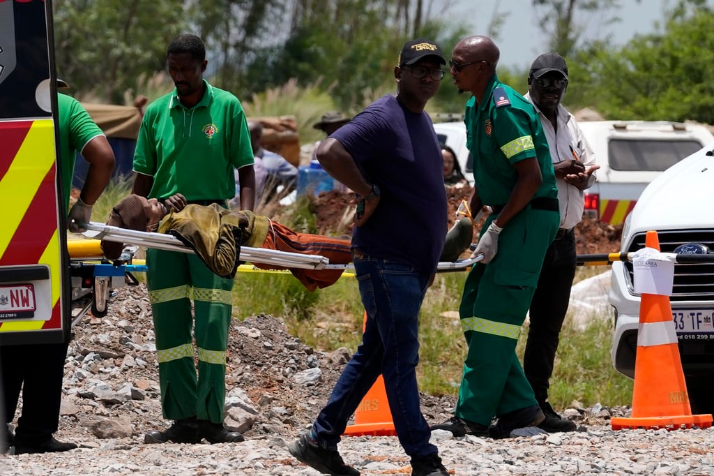 A miner being carried on a stretcher. Photo: AP A miner being carried on a stretcher. Photo: AP