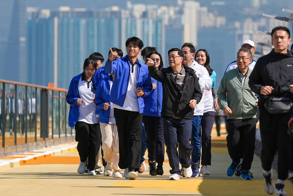 John Lee (centre) joins joggers for a trip along the new boardwalk on Saturday. Photo: Eugene Lee John Lee (centre) joins joggers for a trip along the new boardwalk on Saturday. Photo: Eugene Lee
