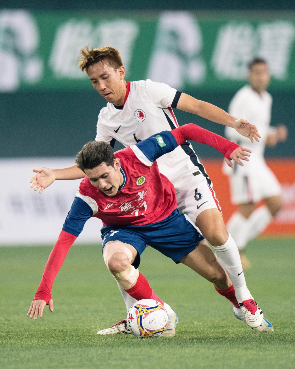 Hong Kong’s Wu Chun-ming (right) challenges Behram Abduweli of Guangdong. Photo: HKFA Hong Kong’s Wu Chun-ming (right) challenges Behram Abduweli of Guangdong. Photo: HKFA
