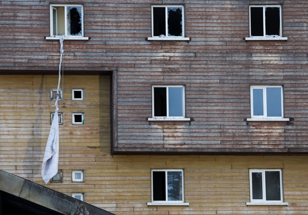 Tied bedsheets hang from a broken window. Photo: Reuters Tied bedsheets hang from a broken window. Photo: Reuters