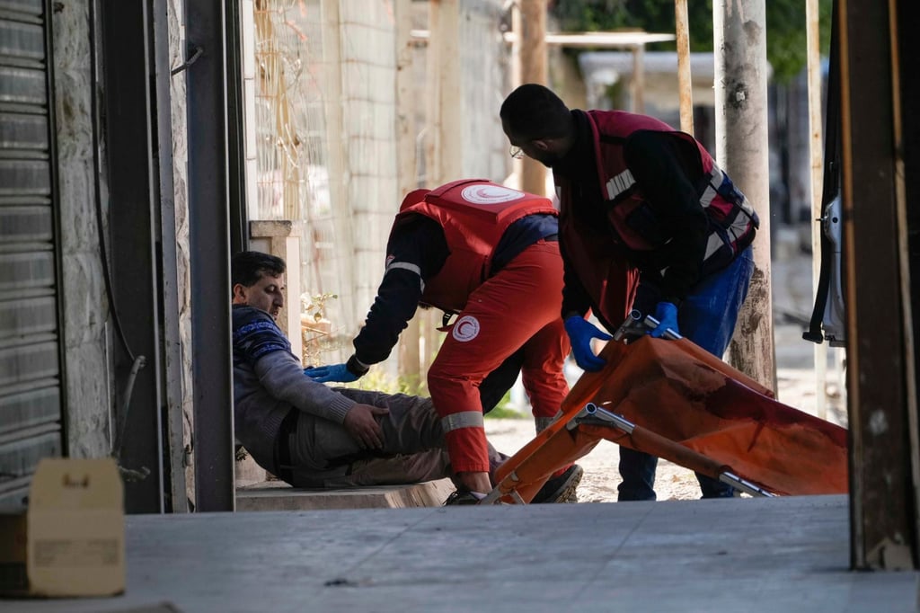 Medics help a wounded man in the West Bank city of Jenin. Photo: AP