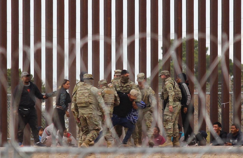 Texas National Guard struggle with a migrant after he crossed across the Rio Grande river to reach the US side. File photo: TNS Texas National Guard struggle with a migrant after he crossed across the Rio Grande river to reach the US side. File photo: TNS