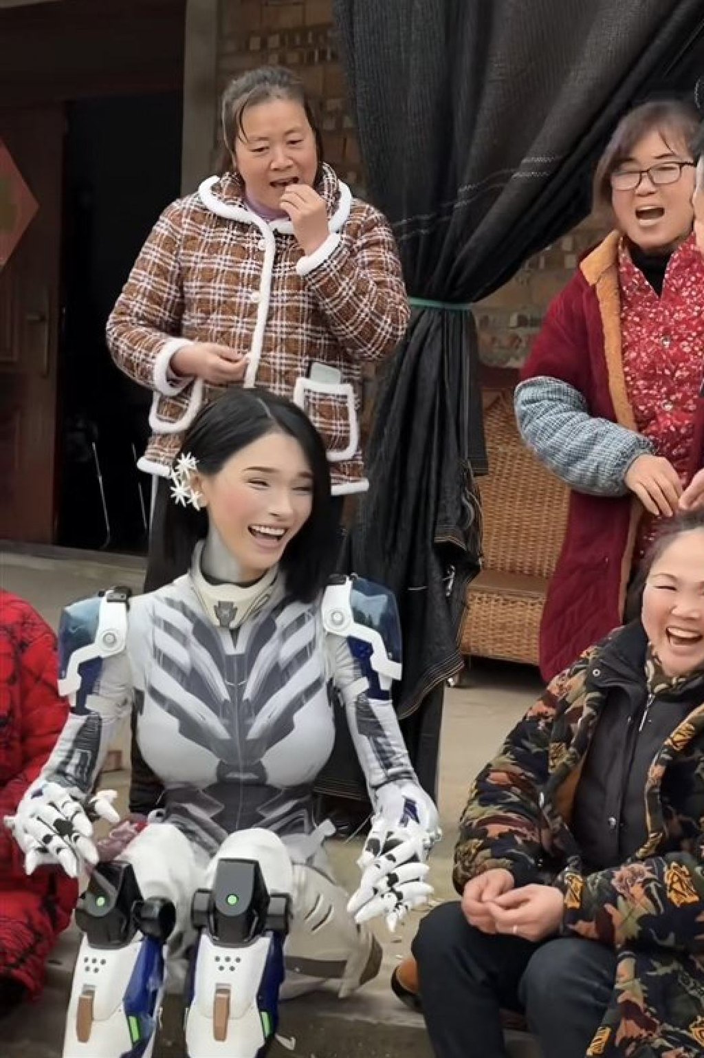 Looking slightly more human, the “robot” laughs and jokes with villagers. Photo: Douyin Looking slightly more human, the “robot” laughs and jokes with villagers. Photo: Douyin