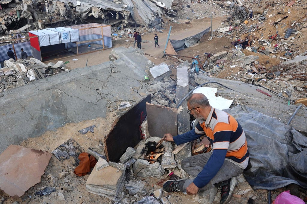 A man prepares coffee on the rubble of a building as displaced Palestinians return to the northern areas of the Gaza Strip, in Jabalia, on Thursday during the Israel-Hamas ceasefire. Photo: AFP A man prepares coffee on the rubble of a building as displaced Palestinians return to the northern areas of the Gaza Strip, in Jabalia, on Thursday during the Israel-Hamas ceasefire. Photo: AFP