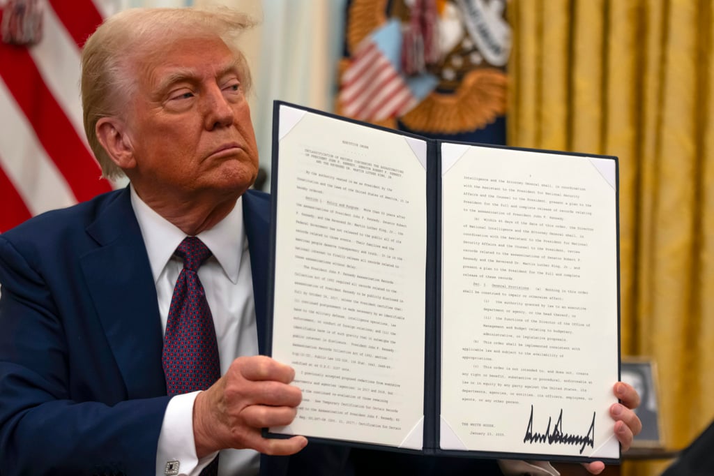 President Donald Trump and the signed executive order. Photo: AP President Donald Trump and the signed executive order. Photo: AP
