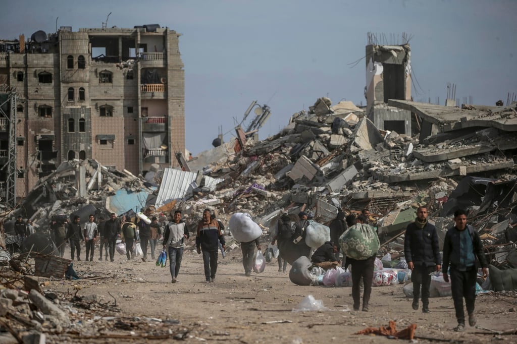 Palestinians walk near destroyed buildings in Rafah, southern Gaza Strip. Photo: EPA-EFE Palestinians walk near destroyed buildings in Rafah, southern Gaza Strip. Photo: EPA-EFE