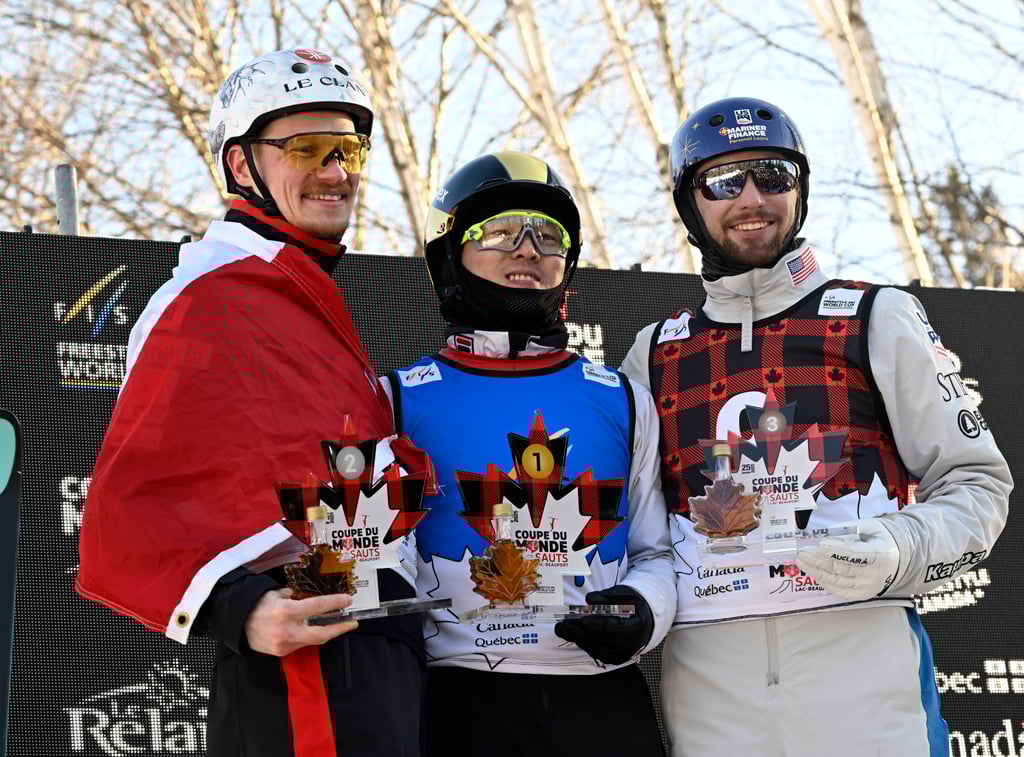 Qi Guangpu is flanked on the podium by Lewis Irving (left) and Christopher Lillis. Photo: AP Qi Guangpu is flanked on the podium by Lewis Irving (left) and Christopher Lillis. Photo: AP