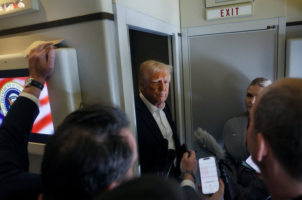 US President Donald Trump speaks with reporters aboard Air Force One on Saturday. Photo: Reuters