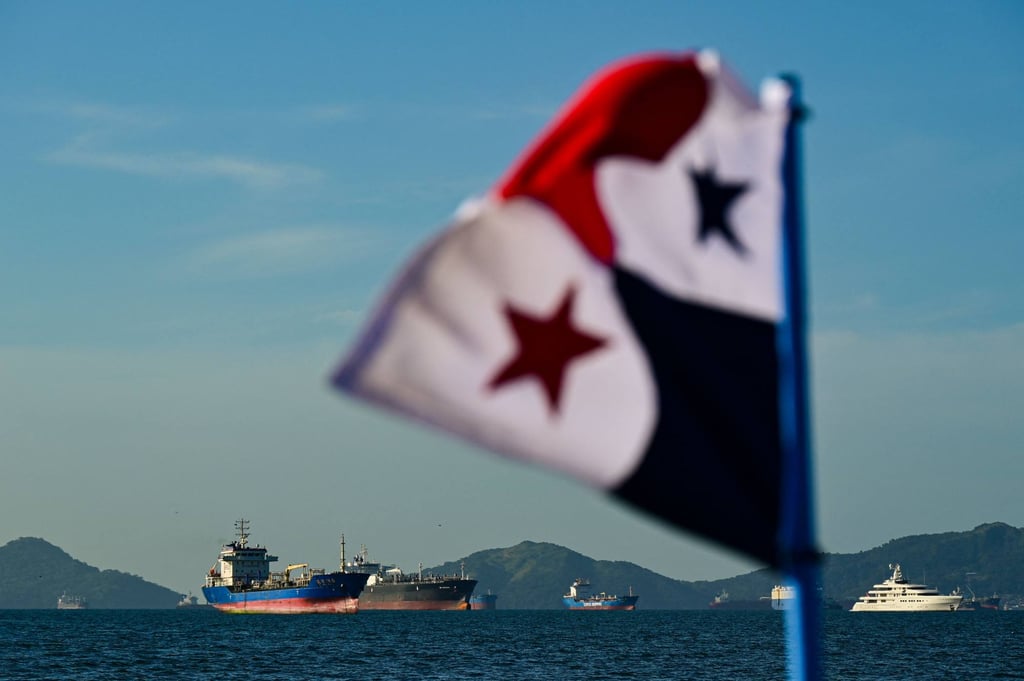A Panamanian flag is pictured in front of cargo ships waiting to enter the Panama Canal. Photo: AFP A Panamanian flag is pictured in front of cargo ships waiting to enter the Panama Canal. Photo: AFP