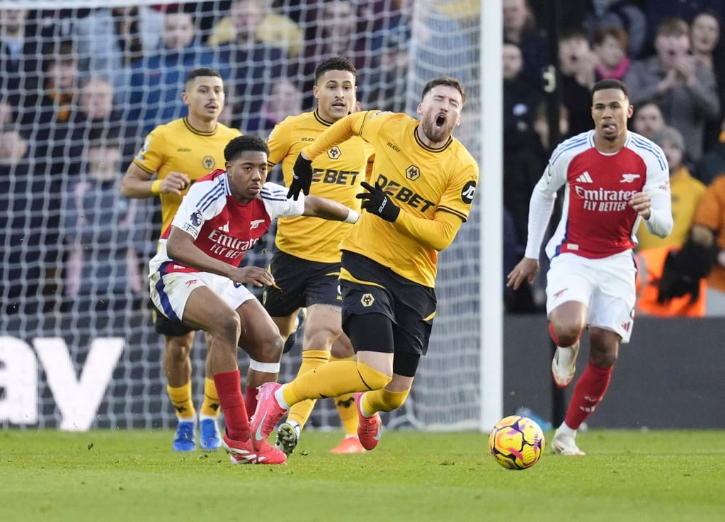 Arsenal’s Myles Lewis-Skelly was sent off for this foul on Wolves’ Matt Doherty. Photo: AP