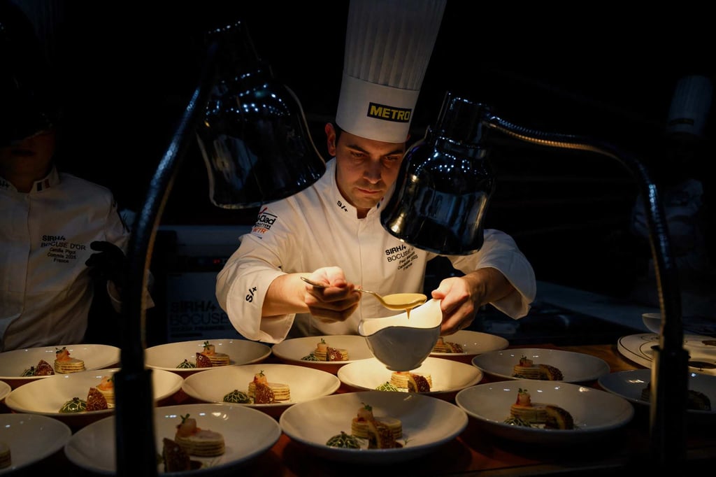 Marcon prepares dishes as he competes in the 2025 Bocuse d’Or cooking competition. Photo: AFP