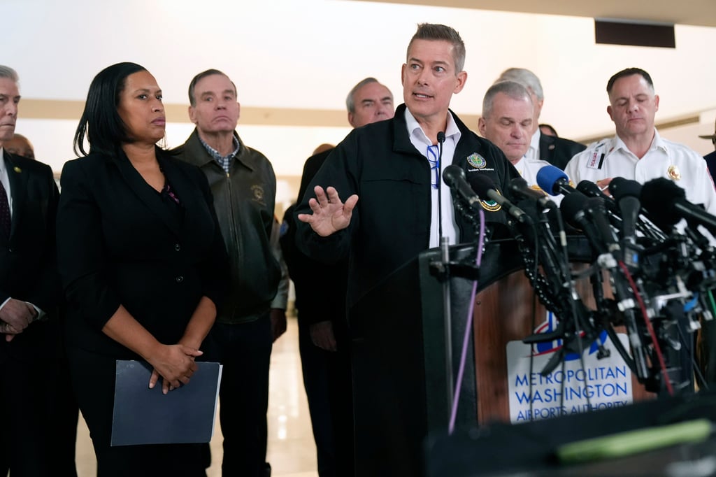 Transportation Secretary Sean Duffy, with District of Columbia Mayor Muriel Bowser, left, and others, speaks during a news conference at Ronald Reagan Washington National Airport, Thursday morning. Photo: AP
