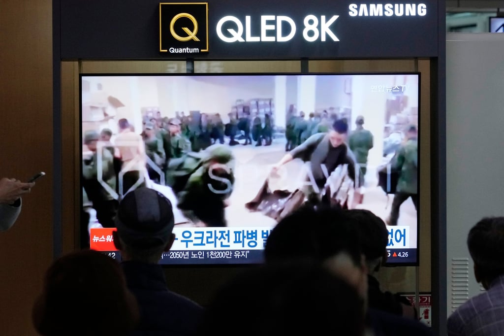A TV screen at Seoul railway station in South Korea in October shows an image of soldiers believed to be from North Korea standing in line to receive supplies from Russia. Photo: AP