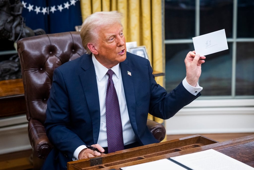 US President Donald Trump holds at a letter from former President Joe Biden left for him in the drawer of the Resolute desk on the first day of his presidency. Photo: EPA-EFE