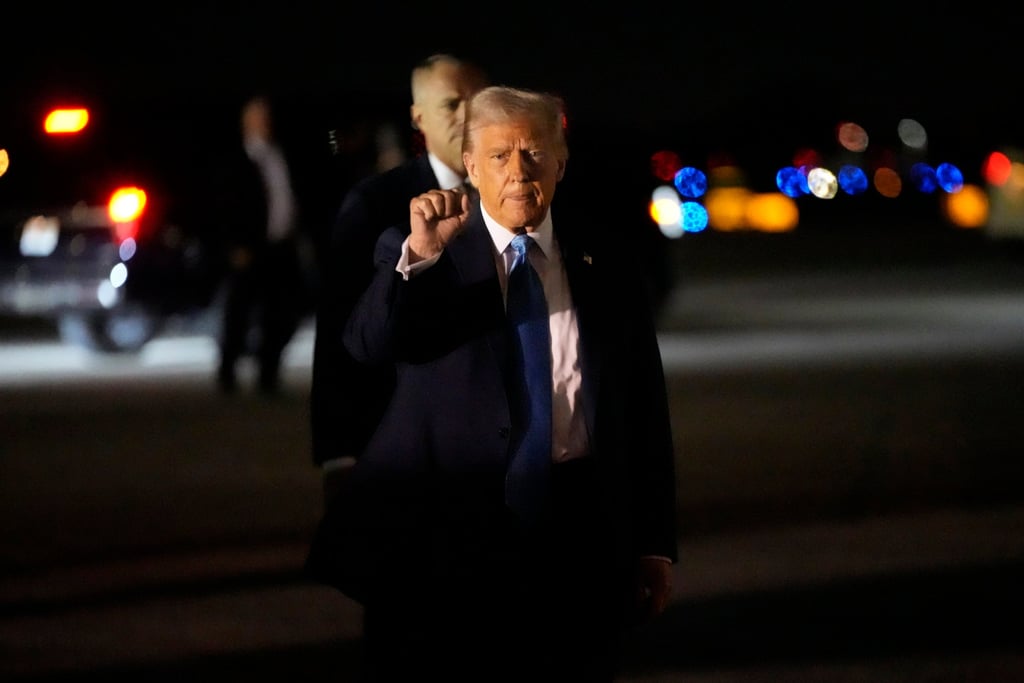 President Donald Trump gestures as he arrives at Palm Beach International Airport en route to his Mar-a-Lago estate in Palm Beach. Photo: AP President Donald Trump gestures as he arrives at Palm Beach International Airport en route to his Mar-a-Lago estate in Palm Beach. Photo: AP