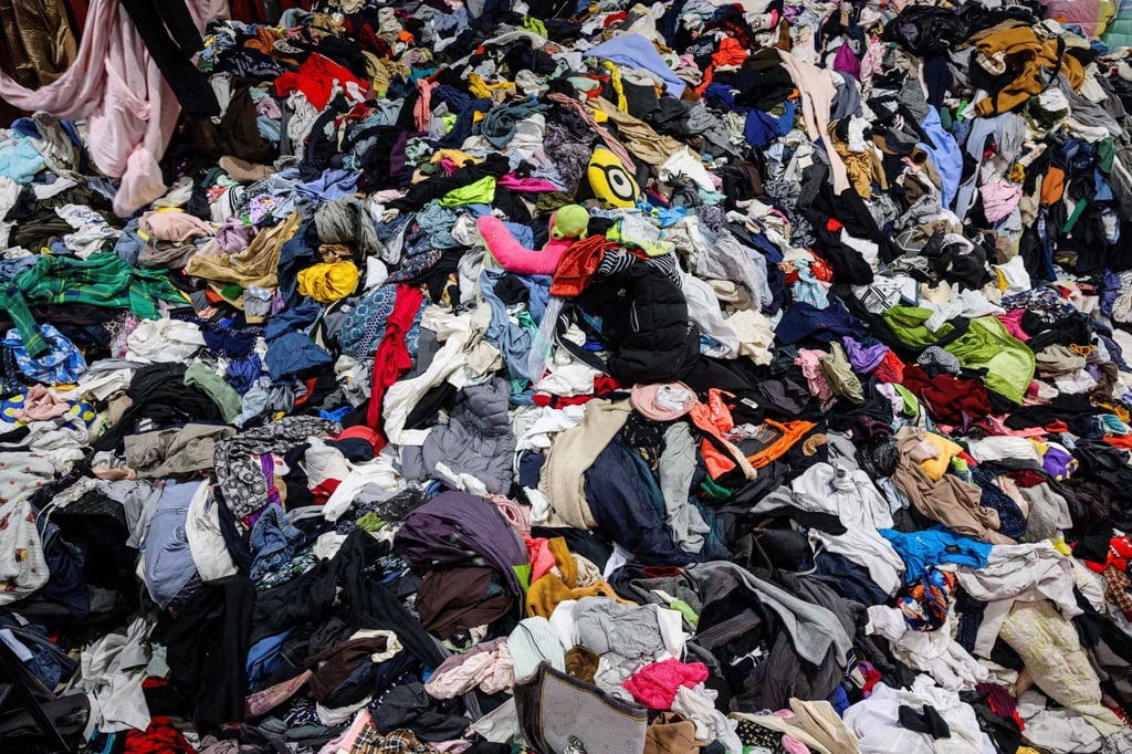 A huge pile of discarded garments, bedding, soft toys and accessories in a South Korean warehouse, before being exported overseas. Photo: AFP A huge pile of discarded garments, bedding, soft toys and accessories in a South Korean warehouse, before being exported overseas. Photo: AFP