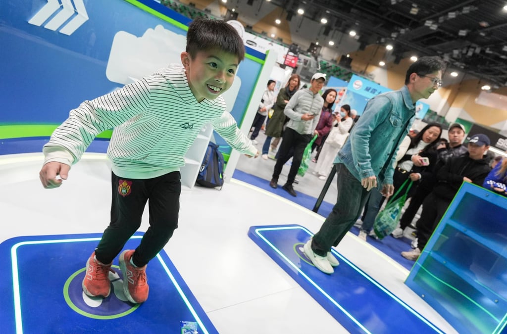 Runners and their families visit the Marathon Expo to play games and take photos at Kai Tak Arena. Photo: Eugene Lee Runners and their families visit the Marathon Expo to play games and take photos at Kai Tak Arena. Photo: Eugene Lee