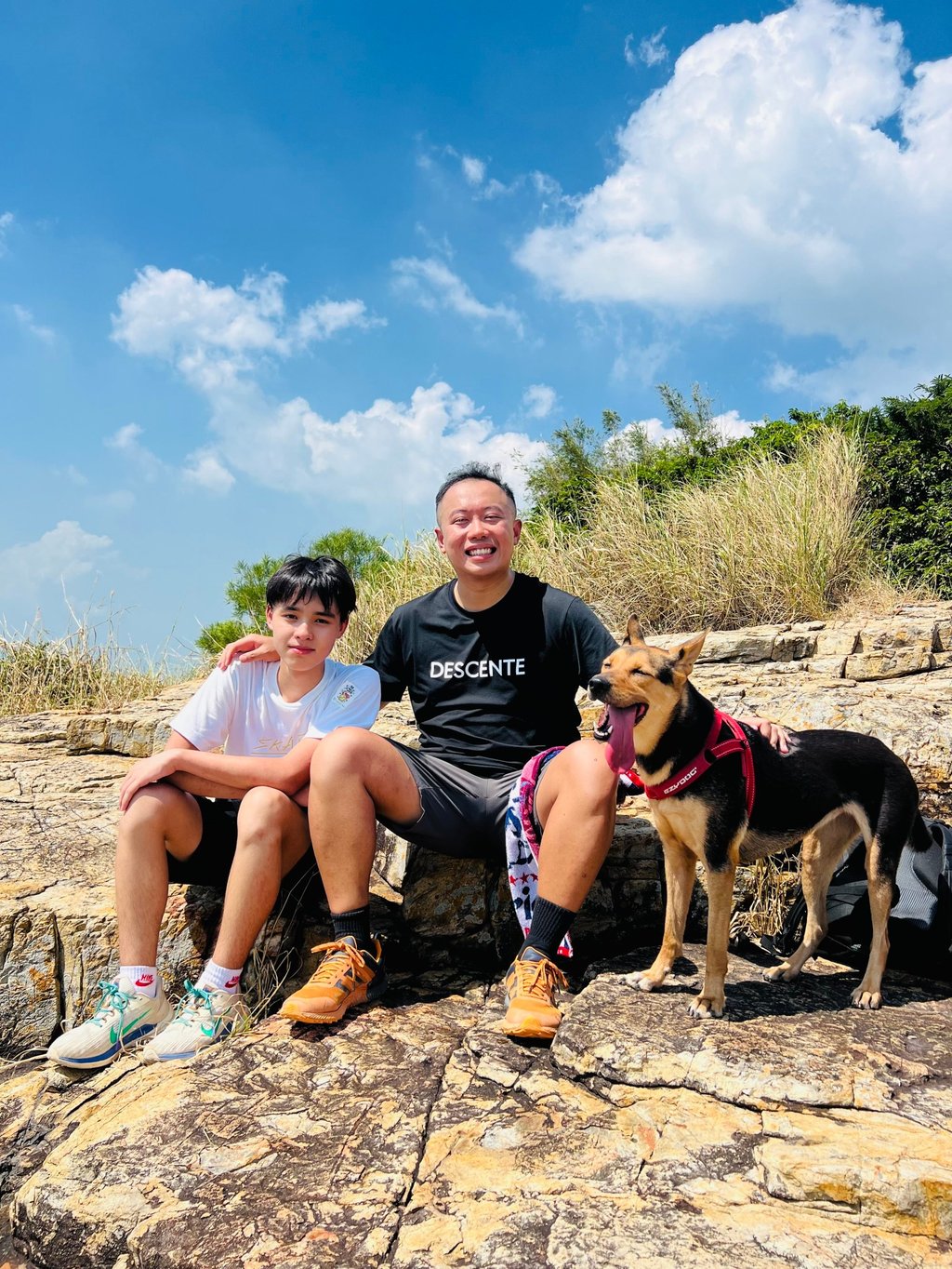 HSBC volunteer Cyrus Chu (centre) took his dog along with mentee Anson Yung on a hiking excursion on Mount Johnston in Hong Kong. HSBC volunteer Cyrus Chu (centre) took his dog along with mentee Anson Yung on a hiking excursion on Mount Johnston in Hong Kong.