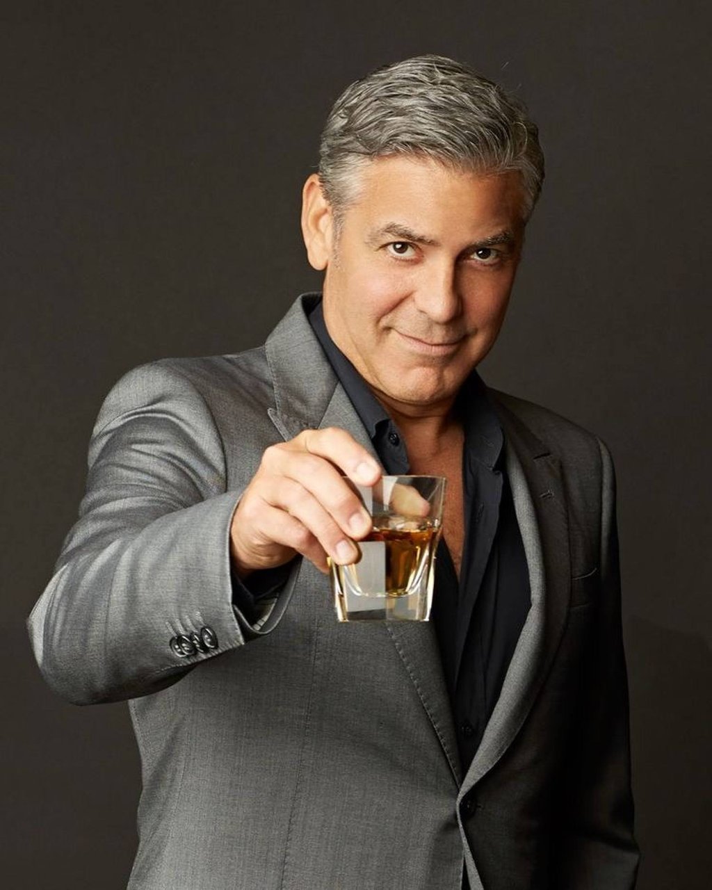 George Clooney raises a glass of tequila from the Casamigos brand he co-founded and which was sold to drinks giant Diageo in a deal worth up to US$1 billion. Photo: Instagram/casamigos