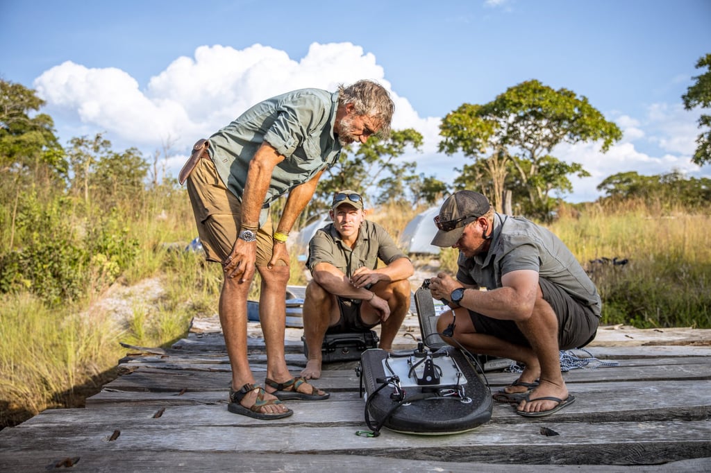 Steve Boyes (left) and two of his research team install acoustic equipment to monitor Cassai River’s currents. Photo: The Wilderness Project/Jesse Manuel