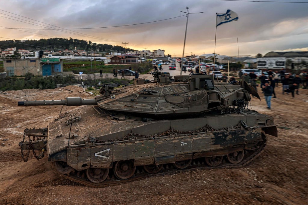 People look on as Israeli tanks enter the Jenin camp for Palestinian refugees. Photo: AFP People look on as Israeli tanks enter the Jenin camp for Palestinian refugees. Photo: AFP