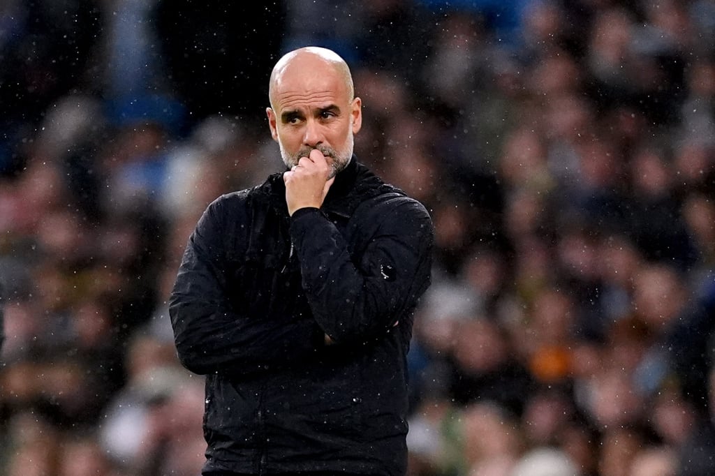 A concerned Pep Guardiola watches on as his Manchester City side are beaten at home to Liverpool. Photo: dpa A concerned Pep Guardiola watches on as his Manchester City side are beaten at home to Liverpool. Photo: dpa