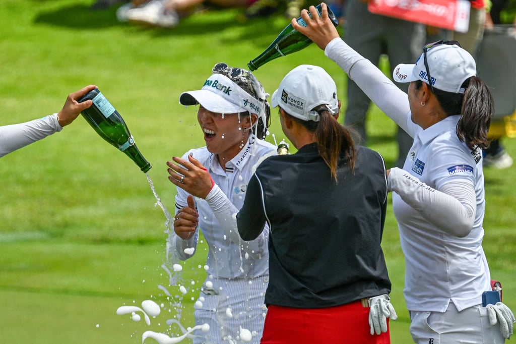 Lydia Ko is showered with champagne after clinching victory at Sentosa Golf Club. Photo: AFP