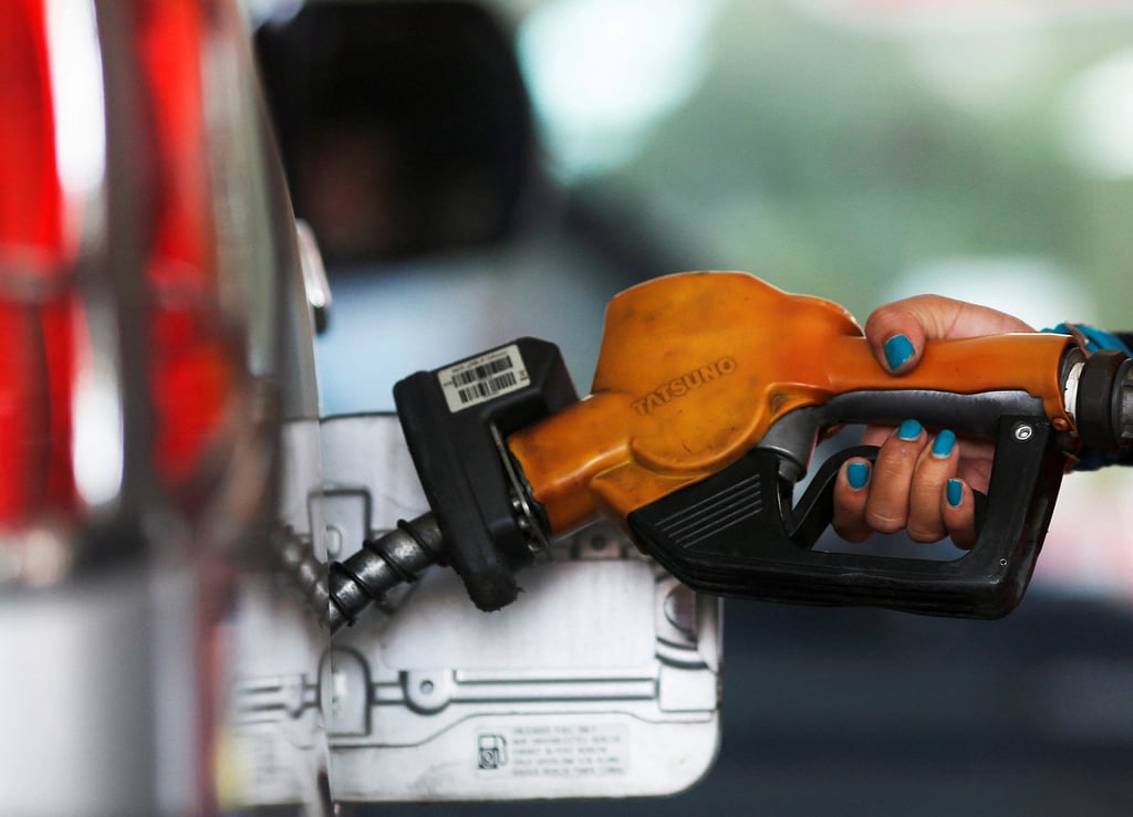 A worker fills a vehicle at a petrol station in Jakarta. Indonesia has increased the mandatory mix of palm oil in its biodiesel. Photo: Reuters A worker fills a vehicle at a petrol station in Jakarta. Indonesia has increased the mandatory mix of palm oil in its biodiesel. Photo: Reuters