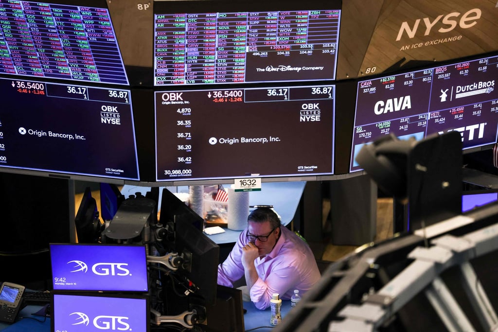 A trader on the floor of the New York Stock Exchange. Photo: AFP A trader on the floor of the New York Stock Exchange. Photo: AFP