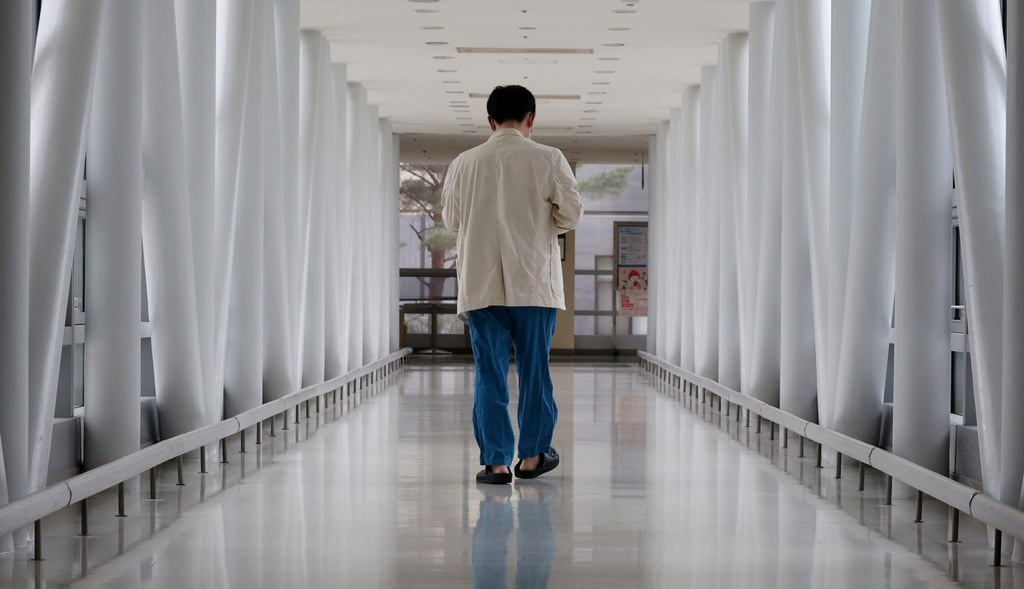 A medical worker walks down a hallway in a hospital in Seoul, South Korea. Medical students in the country face expulsion threats as schools demand their return amid strikes over disputed government admission quotas. Photo: EPA-EFE/Yonhap A medical worker walks down a hallway in a hospital in Seoul, South Korea. Medical students in the country face expulsion threats as schools demand their return amid strikes over disputed government admission quotas. Photo: EPA-EFE/Yonhap
