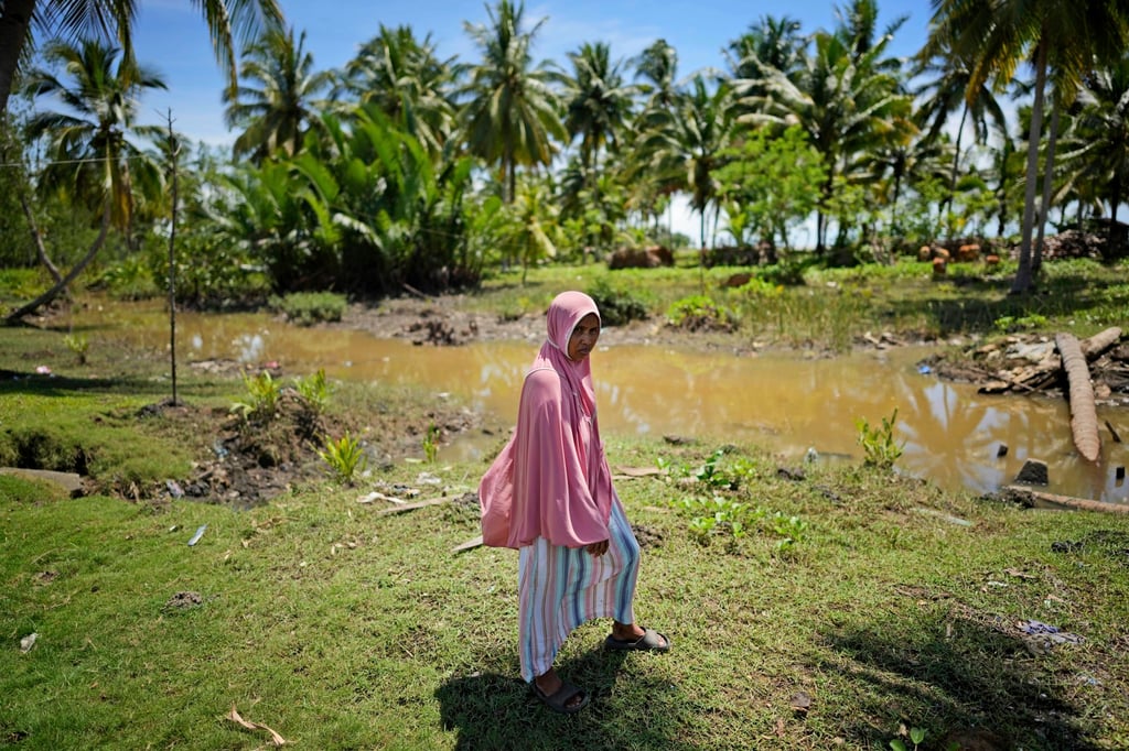Munirpa, a crocodile-attack survivor, at the location where she was nearly killed by a four-metre-long crocodile in Topoyo, West Sulawesi, Indonesia. Photo: AP Munirpa, a crocodile-attack survivor, at the location where she was nearly killed by a four-metre-long crocodile in Topoyo, West Sulawesi, Indonesia. Photo: AP