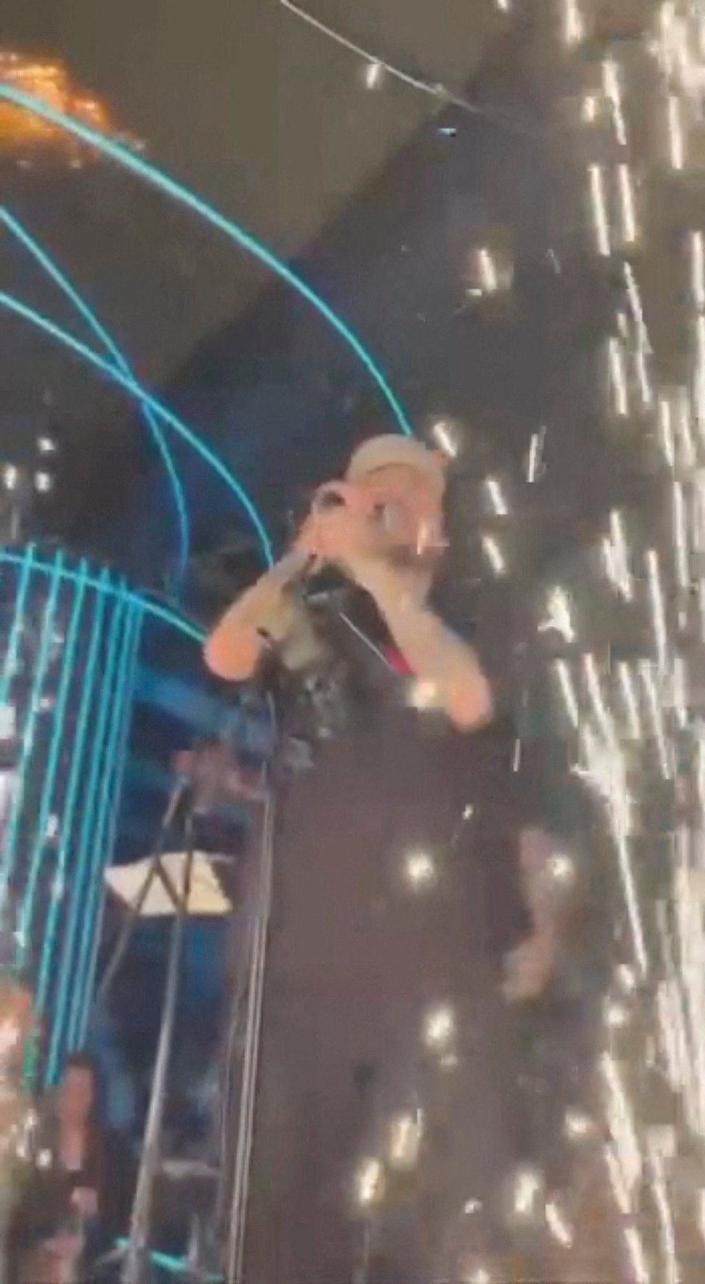 Fire spreads on the roof as fireworks explode during a performance. Social media photo via Reuters