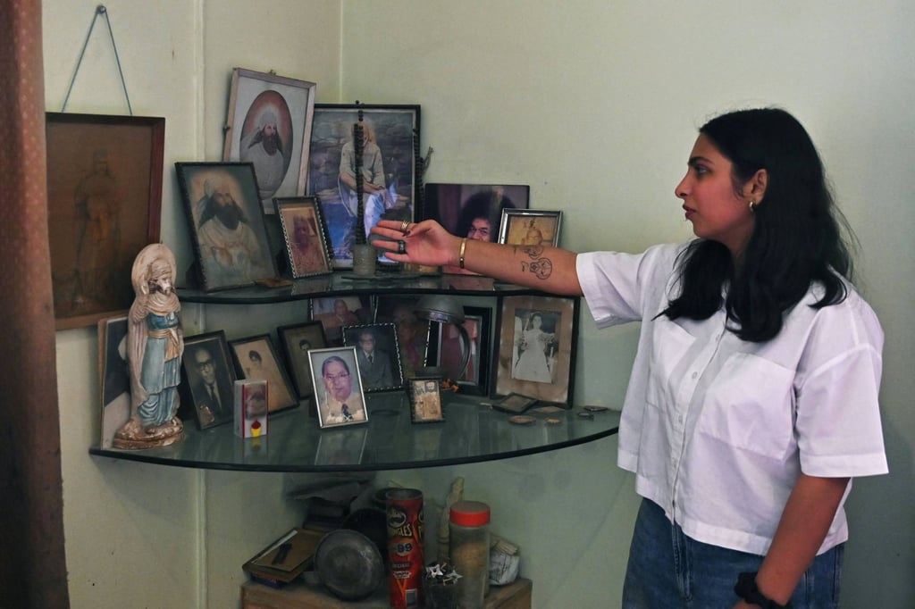 Elisha Amra shows a corner of her grandparents’ home with photos of their prophet Zoroaster and ancestral family members, in a Karachi enclave reserved for Zoroastrians. Photo: AFP Elisha Amra shows a corner of her grandparents’ home with photos of their prophet Zoroaster and ancestral family members, in a Karachi enclave reserved for Zoroastrians. Photo: AFP