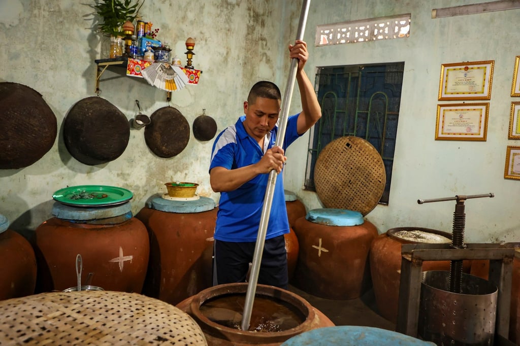 A villager makes fish sauce in his home in Nam O. Photo: AP A villager makes fish sauce in his home in Nam O. Photo: AP