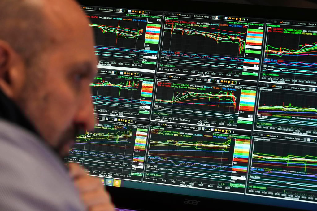 People work on the floor at the New York Stock Exchange in New York. US stocks plunged on Monday amid Trump’s tariff fears, pushing S&P 500 towards its worst quarter since the 1980s. Photo: AP People work on the floor at the New York Stock Exchange in New York. US stocks plunged on Monday amid Trump’s tariff fears, pushing S&P 500 towards its worst quarter since the 1980s. Photo: AP