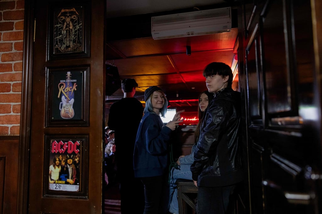 The punk rock band Susidy Sterpliat‘s manager Nadia Kukla checks tickets before a concert in a pub in Vinnytsia, Ukraine. Photo: AFP