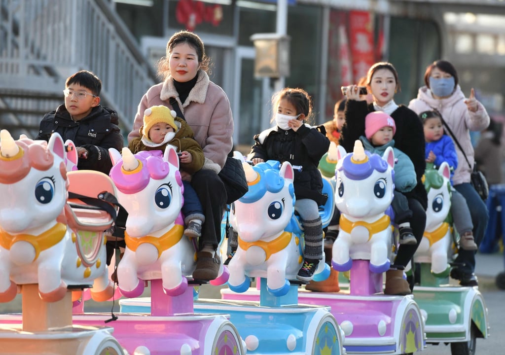 Children take a ride with adults at a park in Fuyang, Anhui province. Nearly one third of Chinese children aged over seven could be overweight or obese by 2030, according to the National Health Commission. Photo: AFP Children take a ride with adults at a park in Fuyang, Anhui province. Nearly one third of Chinese children aged over seven could be overweight or obese by 2030, according to the National Health Commission. Photo: AFP