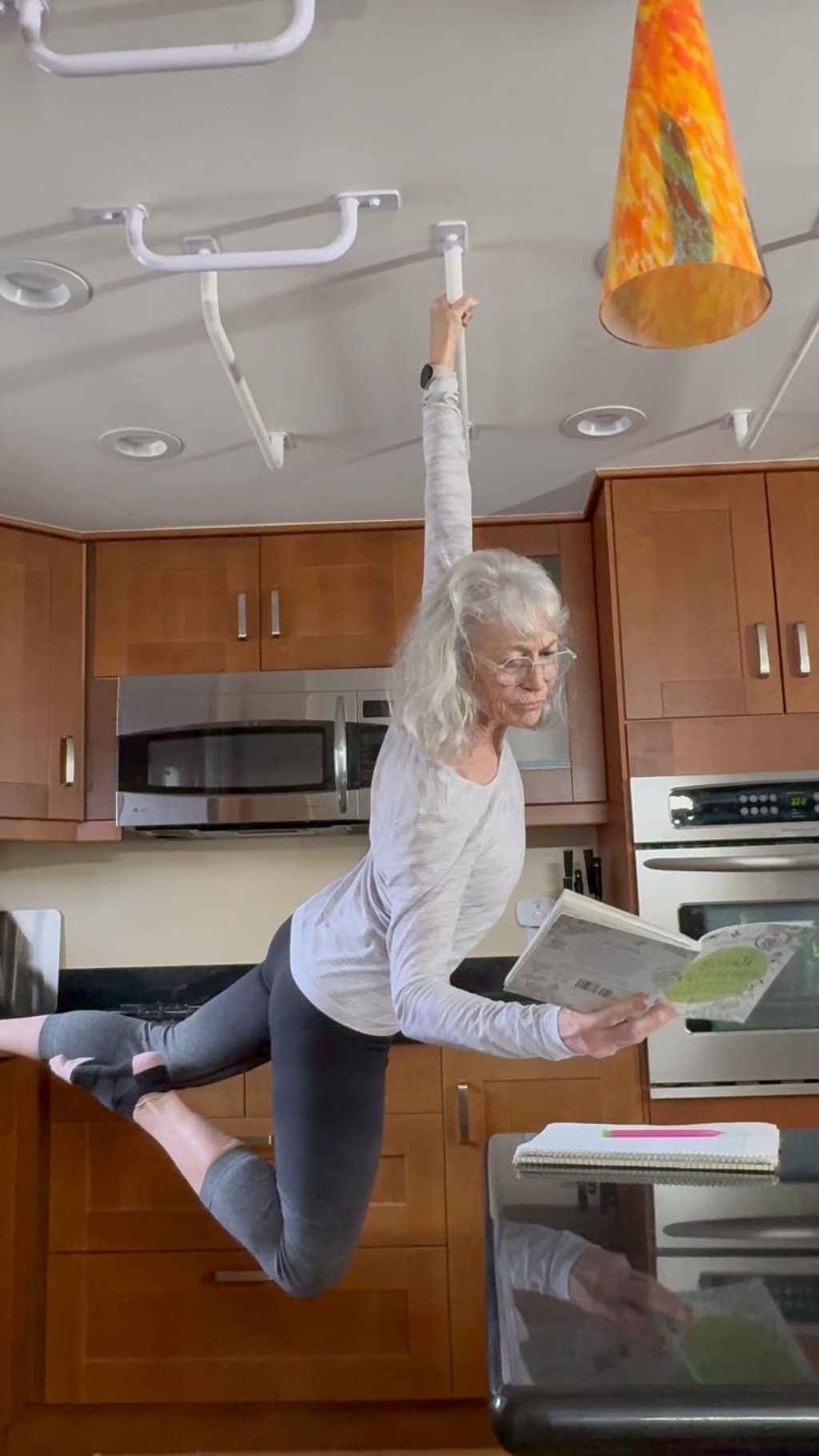 MacColl even “hangs out” on monkey bars installed in the kitchen while preparing cups of tea. Hanging is good for your health, and grip strength is a biomarker of longevity, MacColl writes on Instagram. Photo: Instagram/ginnymaccoll MacColl even “hangs out” on monkey bars installed in the kitchen while preparing cups of tea. Hanging is good for your health, and grip strength is a biomarker of longevity, MacColl writes on Instagram. Photo: Instagram/ginnymaccoll