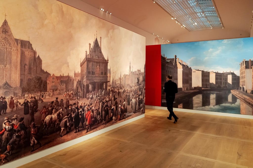 A visitor looks at enlarged sections of paintings at the ‘From Rembrandt to Vermeer, Masterpieces from The Leiden Collection’ exhibition. Photo: EPA-EFE