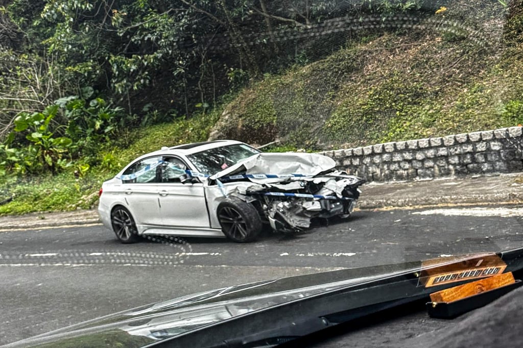 The vehicle hit a paved retaining wall with such force that it was propelled upwards, passing above another car (pictured) in the opposite lane before landing back on the road. Photo: handout The vehicle hit a paved retaining wall with such force that it was propelled upwards, passing above another car (pictured) in the opposite lane before landing back on the road. Photo: handout