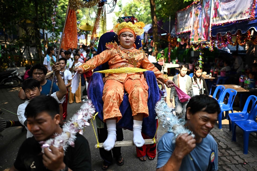 Eleven-year-old Jomwong Koling, an ethnic Shan boy, is carried during the annual Poy Sang Long procession at Wat Ku Tao, in Chiang Mai, northern Thailand. Photo: AFP