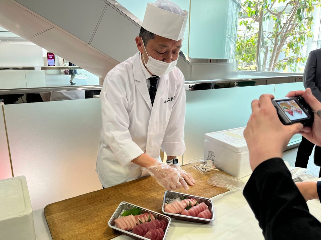 A sushi chef shows how different fatty and lean tuna look and serves both at a Fujitsu facility in Kawasaki, outside Tokyo. Photo: AP A sushi chef shows how different fatty and lean tuna look and serves both at a Fujitsu facility in Kawasaki, outside Tokyo. Photo: AP