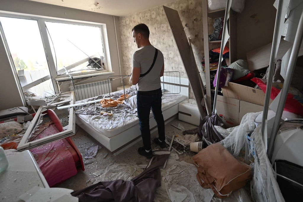 A man stands inside his damaged flat following a Russian missile attack on Kharkiv, Ukraine, on Friday. Photo: AFP