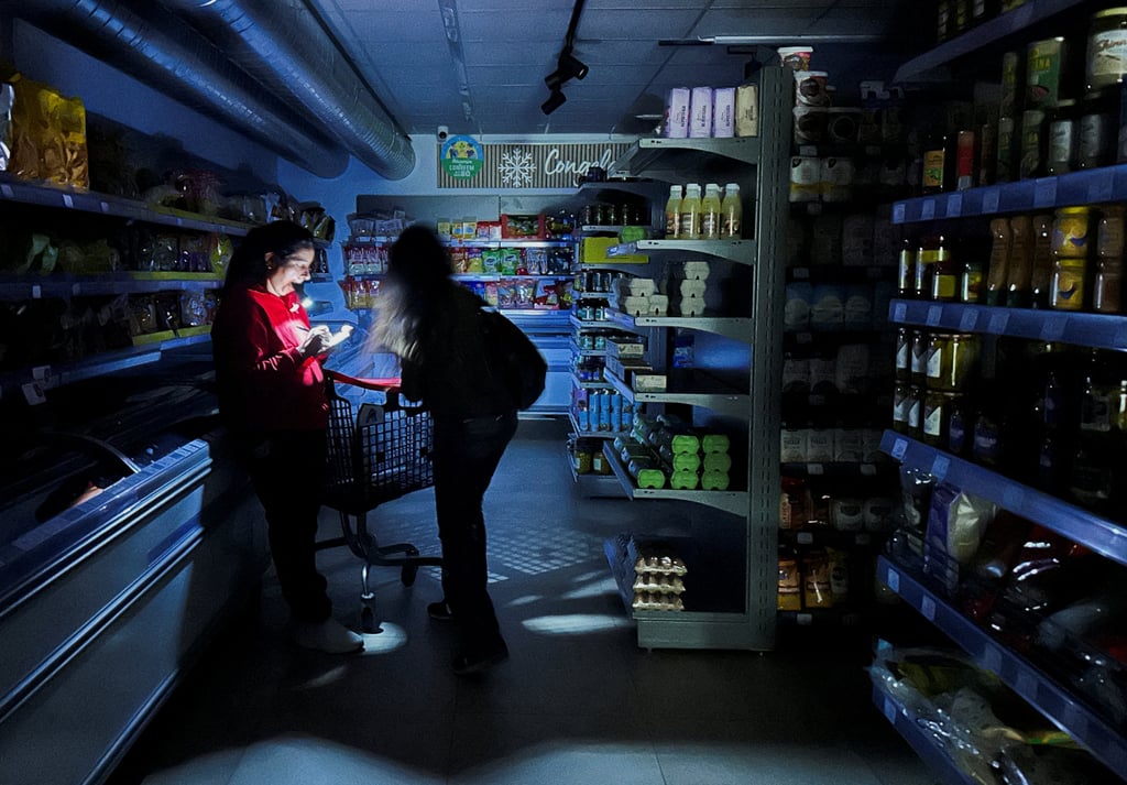 A worker assists a customer at a supermarket. Photo: Reuters