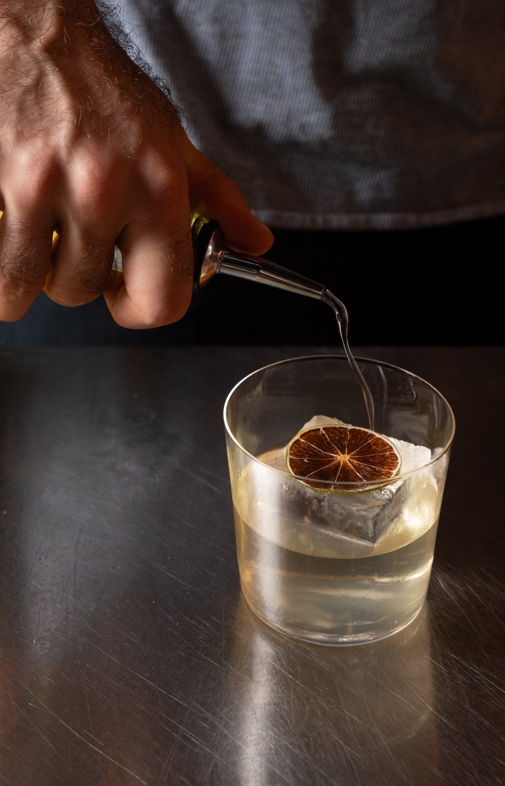Jack Byrne, manager of Paragon, in the process of making Rosas Milk Punch, topped with a gummy made from upcycled citrus. Photo: Alexander Mak Jack Byrne, manager of Paragon, in the process of making Rosas Milk Punch, topped with a gummy made from upcycled citrus. Photo: Alexander Mak