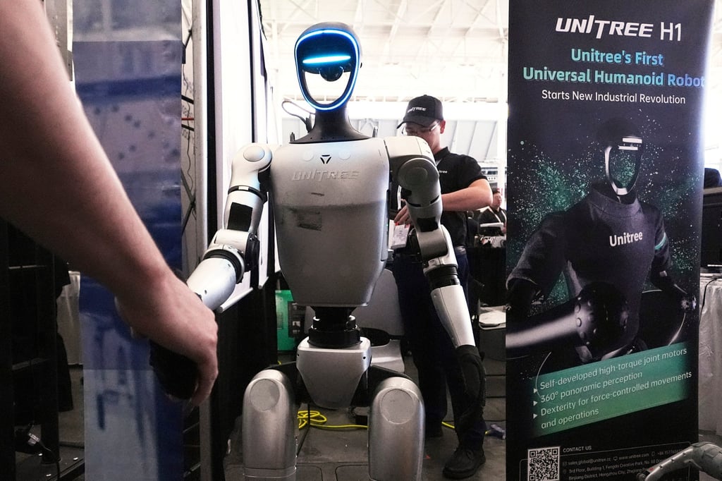 A Unitree robot shakes hands with a convention guest at the Robotics Summit & Expo, Wednesday, April 30, 2025, in Boston. (AP Photo/Charles Krupa) A Unitree robot shakes hands with a convention guest at the Robotics Summit & Expo, Wednesday, April 30, 2025, in Boston. (AP Photo/Charles Krupa)