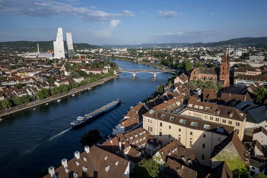 A barge nears Basel cathedral (right) with the towers housing the headquarters of pharmaceutical company Roche to the left. The Rhine is clean enough to swim in these days. Photo: AFP A barge nears Basel cathedral (right) with the towers housing the headquarters of pharmaceutical company Roche to the left. The Rhine is clean enough to swim in these days. Photo: AFP